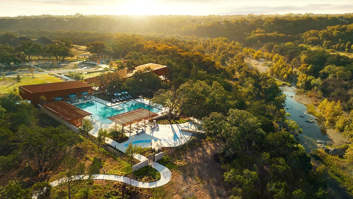 Aerial view of the Wolf Ranch amenity center and the San Gabriel River valley at sunset, Georgetown, Texas